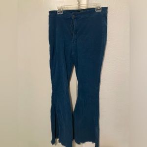 Teal flare bells with distressed bottoms